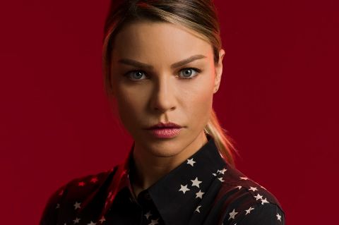 Lauren German in a black shirt poses for a picture.
